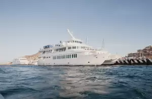Superyacht charter in Los Cabos docked along the Cabo San Lucas waterfront, highlighting private yacht experiences on the Baja California coast.