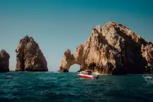 Catamaran rental in Los Cabos cruising near El Arco and Land's End, offering scenic views of Cabo San Lucas from the water.